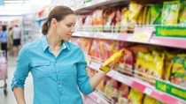 Woman checking food labelling Woman checking food labelling