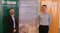Two people standing in front of BASF banners Two people standing in front of BASF banners