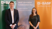 Two people standing in front of BASF banners Two people standing in front of BASF banners