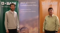 Two people standing in front of BASF banners Two people standing in front of BASF banners
