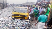 A street full of rubbish through which a car can hardly pass A street full of rubbish through which a car can hardly pass