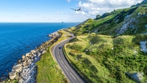 Causeway Coastal Route with cars, a.k.a. Antrim Coastal Road on eastern coast of Northern Ireland, UK. Causeway Coastal Route with cars, a.k.a. Antrim Coastal Road on eastern coast of Northern Ireland, UK.