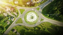 Aerial view of a grassy roundabout with four exits, surrounded by trees and green fields - scientific equations and sketches highlighting the flow of traffic are overlaid on the picture.  Aerial view of a grassy roundabout with four exits, surrounded by trees and green fields - scientific equations and sketches highlighting the flow of traffic are overlaid on the picture.
