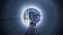 A view from above of several people working on a platform. A view from above of several people working on a platform.