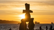 Inukshuk near the coast with a sunset view Inukshuk near the coast with a sunset view