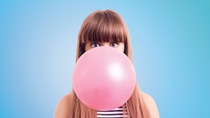 Woman with chewing gum bubble in front of her face. Woman with chewing gum bubble in front of her face.
