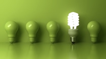 Five green light bulbs lined up against a green background, with the fourth bulb being a lit. Five green light bulbs lined up against a green background, with the fourth bulb being a lit.