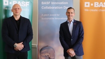 Two people standing in front of BASF banners Two people standing in front of BASF banners