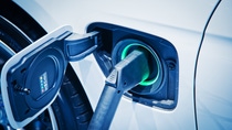 A close-up of an electric charger in an electric car. A close-up of an electric charger in an electric car.
