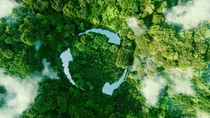 Aerial view of a lush green forest with wisps of cloud and three narrow lakes shaped like a circle of three arrows to symbolize recycling.  Aerial view of a lush green forest with wisps of cloud and three narrow lakes shaped like a circle of three arrows to symbolize recycling.