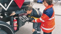 Two people inspecting fire extingusher Two people inspecting fire extingusher