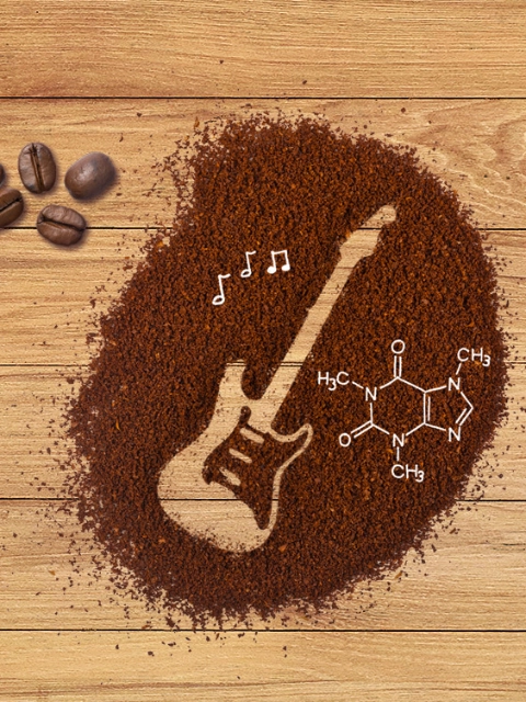 Electric guitar drawn as an outline in a heap of coffee grounds