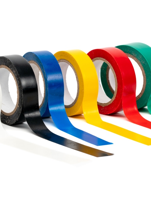 Photo multi colored insulating tapes on a white background.