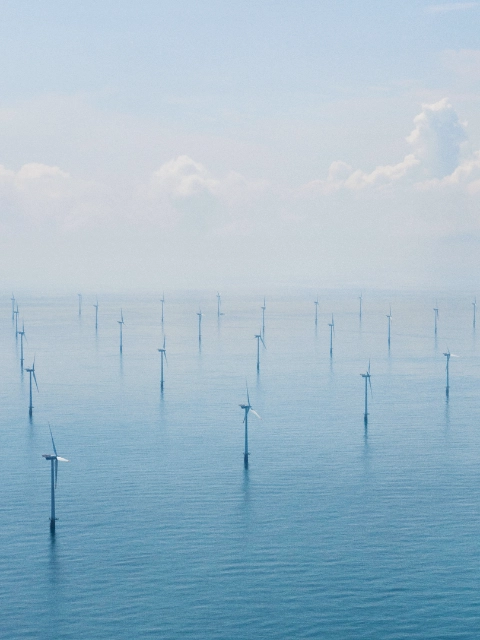 View from above showing several wind turbines in a offshore wind farm 