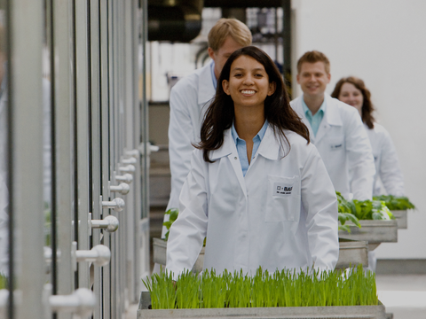 A smiling young woman in laboratory clothing. A smiling young woman in laboratory clothing.