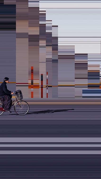 A person rides a bicycle through the city, with the background blurred