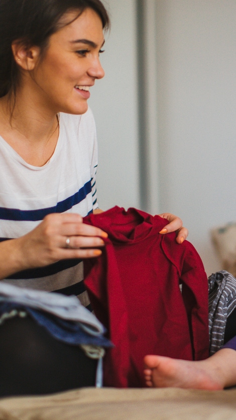 Mother and her daughter folding laundry together