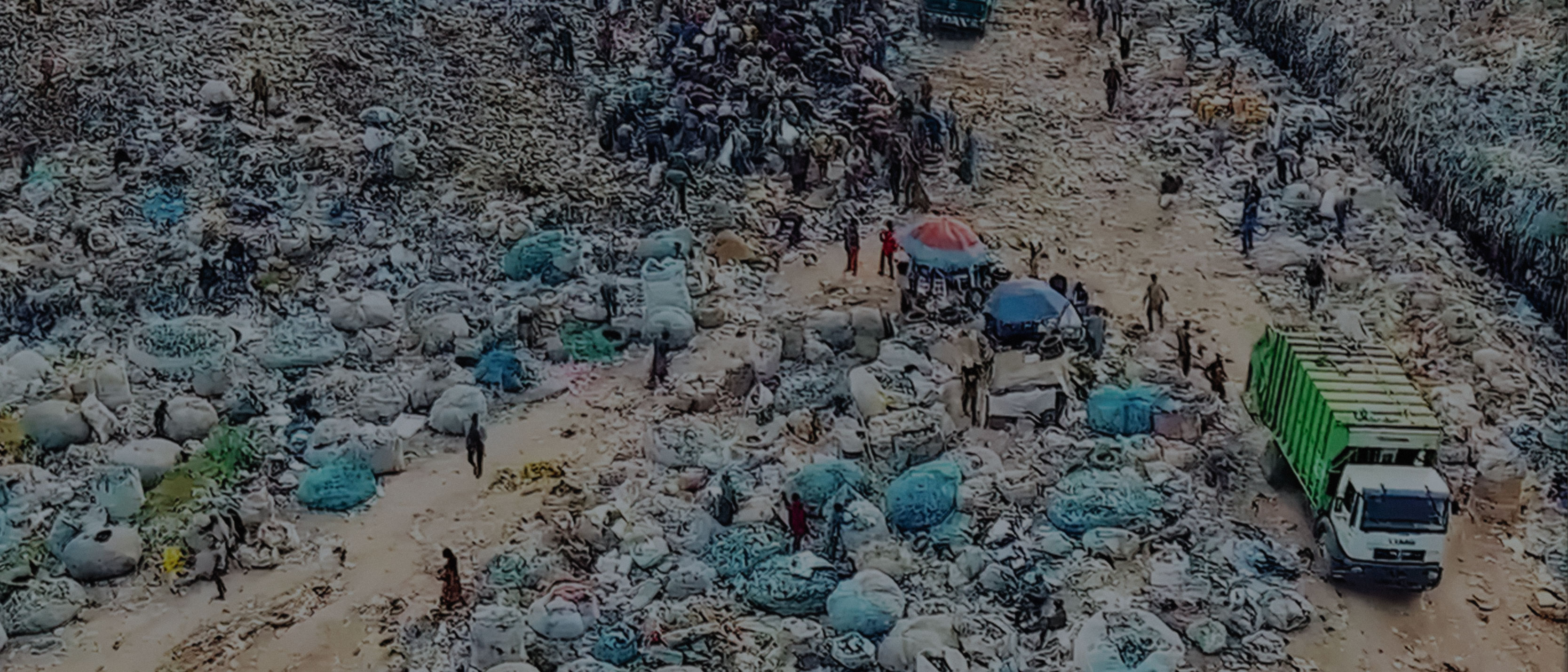 People pick up rubbish on a street full of plastic and rubbish bags