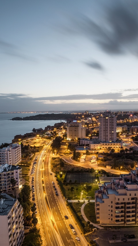 City at rhe bank of the ocean with buidings and hotels during sunset. Vew from above. Portimao, Algarve, Portugal.