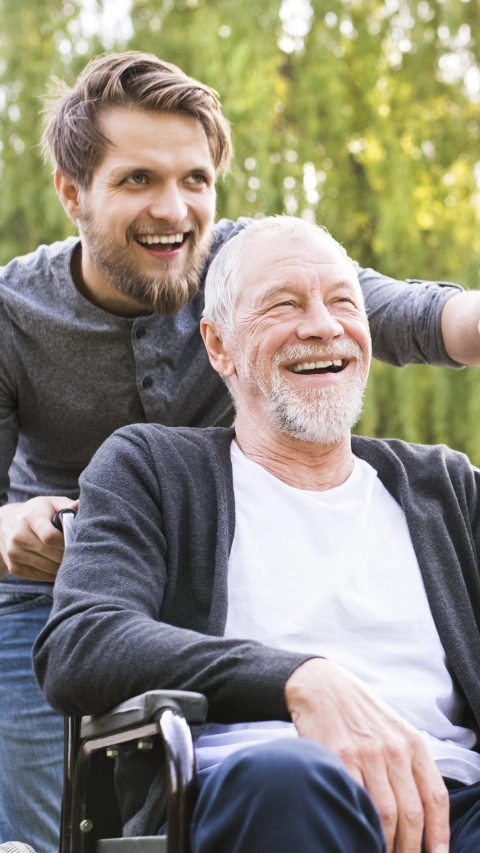 Hipster son walking with disabled father in wheelchair at park.; Shutterstock ID 655349716; Jobnummer: 20728885; Projekt: Pros LuMit; Endkunde: BASF SE; Sonstiges: BASF SE, ESI/K, Frau Peichl