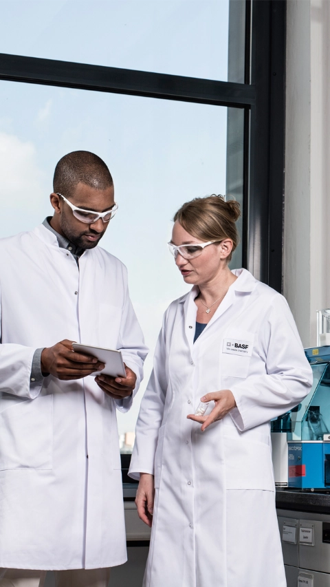 Two scientists discussing work in a lab 