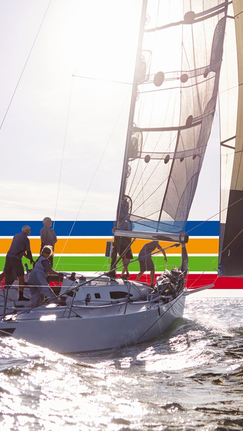 People on a sailing boat in the ocean, under a bright sky, surrounded by a key visual of four lines in blue, orange, green and red (photoshopped)