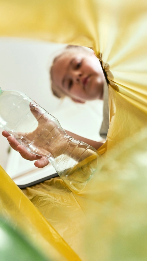 Low angle view of girl throwing a bottle, Poland, podkarpackie, DÄbica