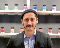 Profile photo of David Kremer in front of a shelf with pigments. Profile photo of David Kremer in front of a shelf with pigments.