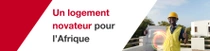Un homme portant un gilet de sécurité jaune et un casque de sécurité se tient devant un bâtiment, tenant un carreau de construction. Des tourbillons lumineux apparaissent près de la main de la personne. Le texte indique : « Des logements innovants pour l’Afrique. » Un homme portant un gilet de sécurité jaune et un casque de sécurité se tient devant un bâtiment, tenant un carreau de construction. Des tourbillons lumineux apparaissent près de la main de la personne. Le texte indique : « Des logements innovants pour l’Afrique. »