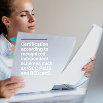 Person holding a document with text about certification according to recognized independent standards. Person holding a document with text about certification according to recognized independent standards.